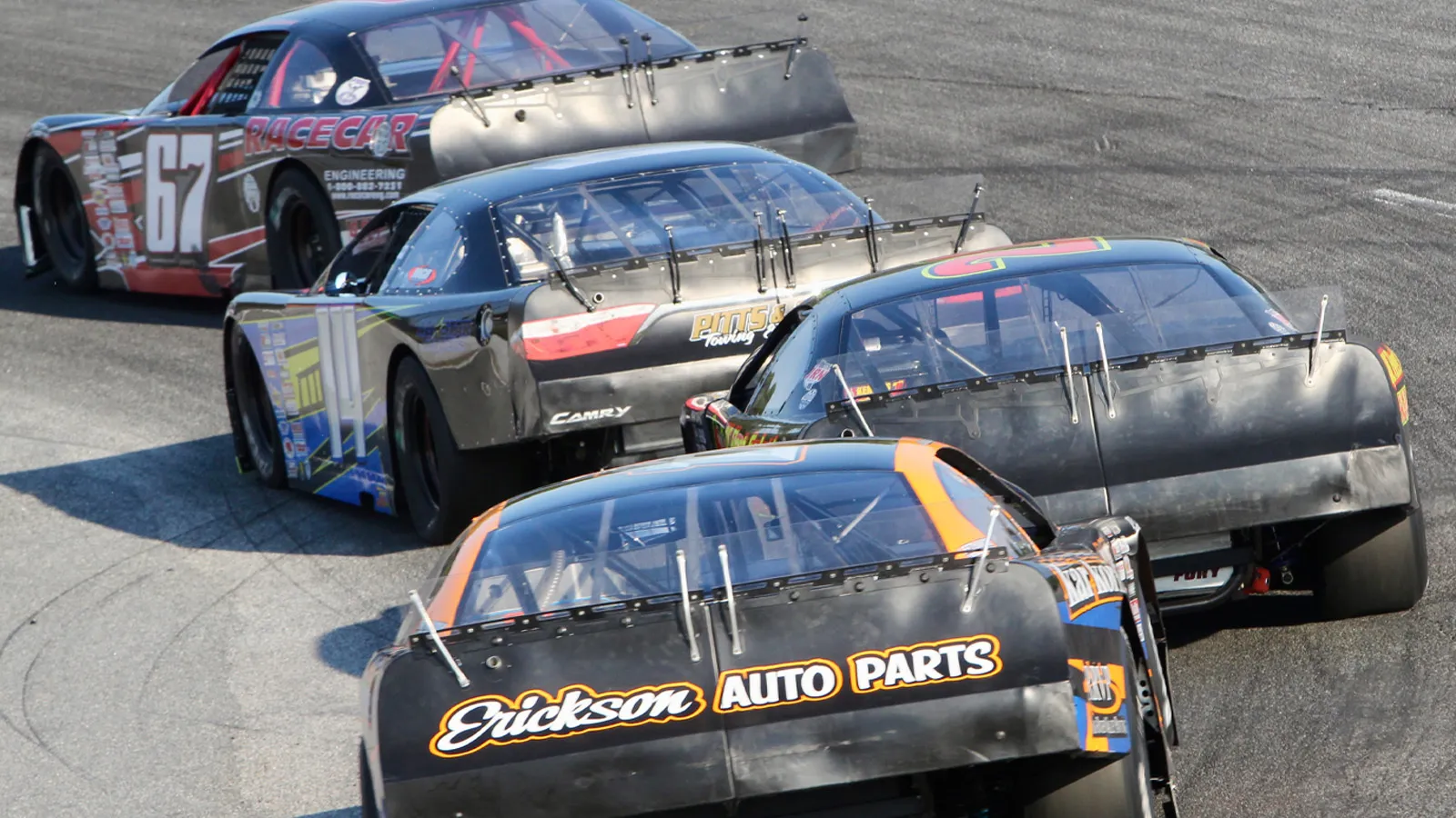 Four late models nose to tail through a turn at Cordele Motor Speedway